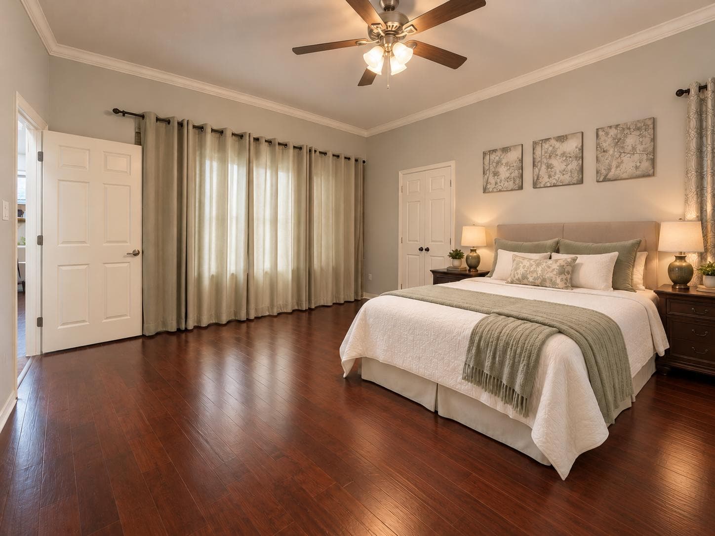 A fully furnished private bedroom with warm bedside lighting